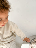 Toddler wearing unisex organic cotton green jumper in a boxy fit with white Bobby G embroidery and matching pants. 